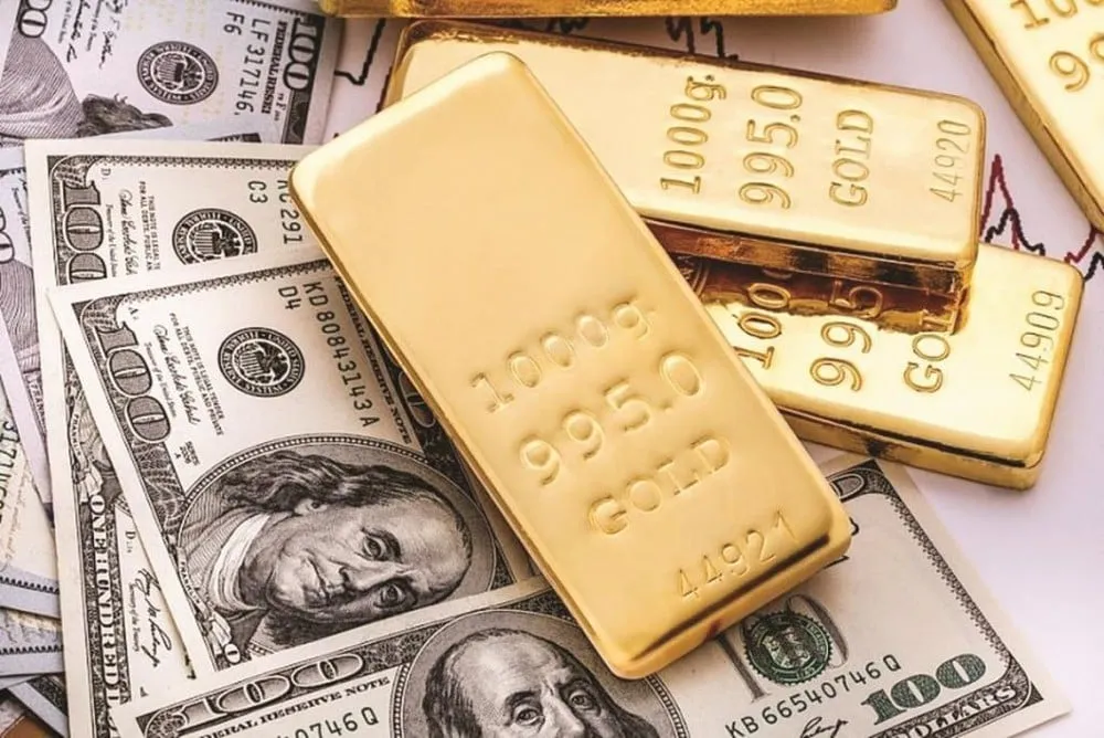 Gold bars stacked on 100 USD notes
