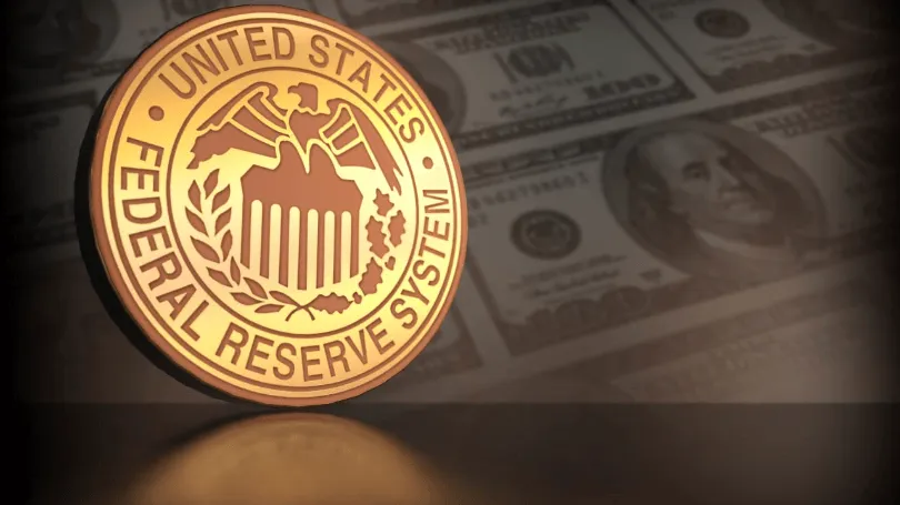 The Federal Reserve System seal against a background of US dollar notes