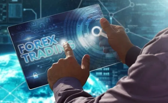 A hand touching a tablet that displays the words Forex Trading